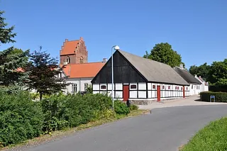 Historische Gebäude und Kirchturm unter blauem Himmel.